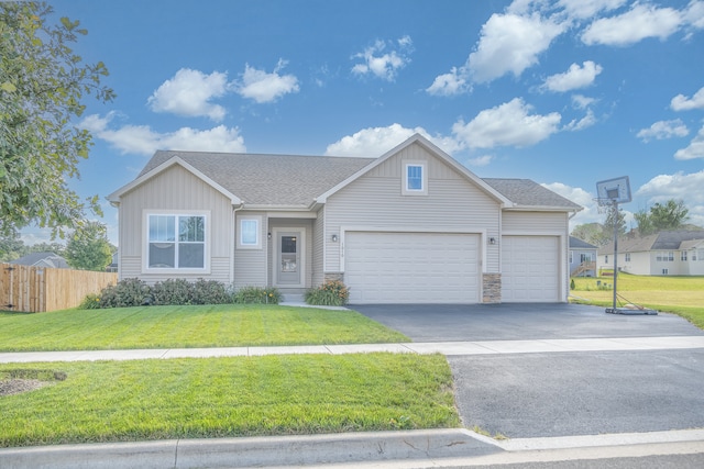 view of front of home featuring a garage and a front lawn