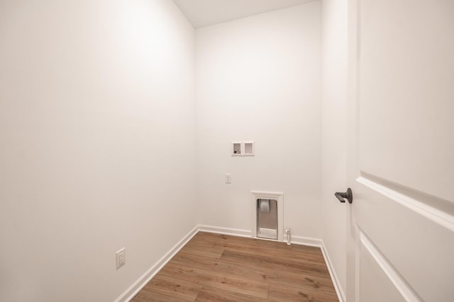 laundry room featuring laundry area, wood finished floors, hookup for a washing machine, and baseboards