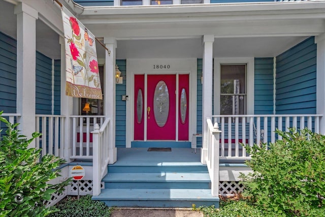 view of exterior entry featuring a porch