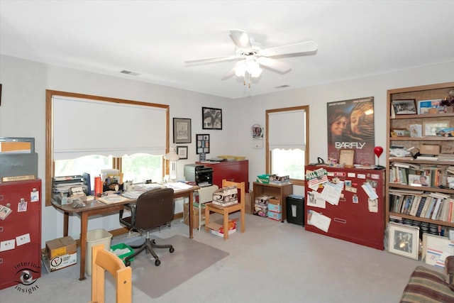 carpeted home office featuring visible vents and a ceiling fan