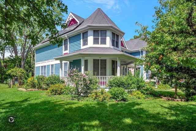 victorian house with covered porch and a front lawn