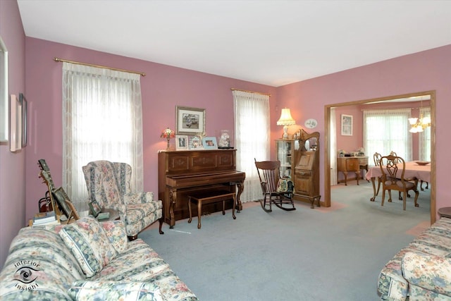 living room with carpet floors and a notable chandelier