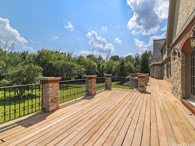 wooden terrace with a lawn