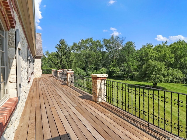 wooden terrace with a lawn