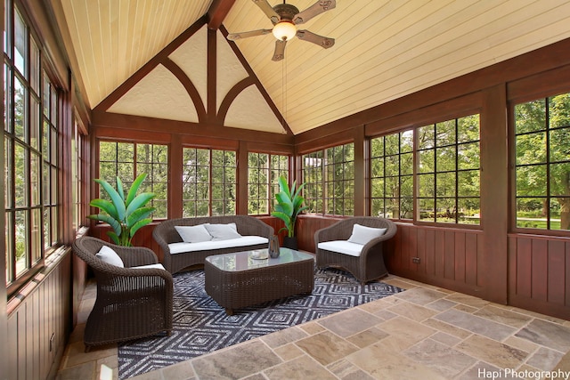 sunroom with ceiling fan and vaulted ceiling