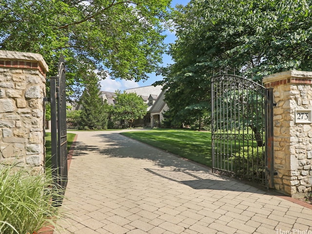 view of gate with a yard