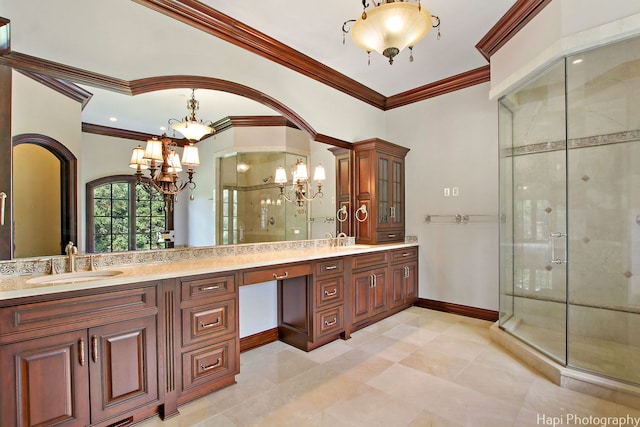 bathroom with vanity, a notable chandelier, ornamental molding, and a shower with door