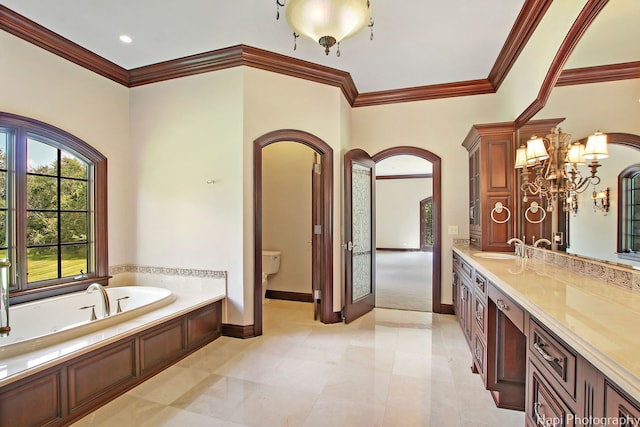 bathroom featuring ornamental molding, vanity, a bathtub, and toilet