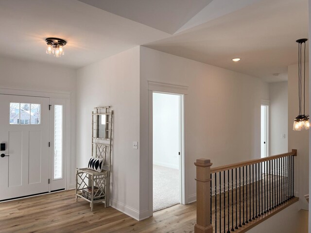 interior space with hardwood / wood-style flooring and lofted ceiling