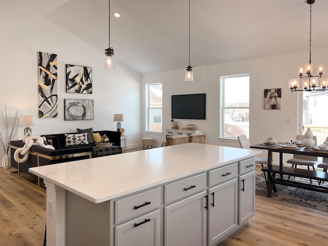 kitchen featuring hanging light fixtures, a center island, and a wealth of natural light