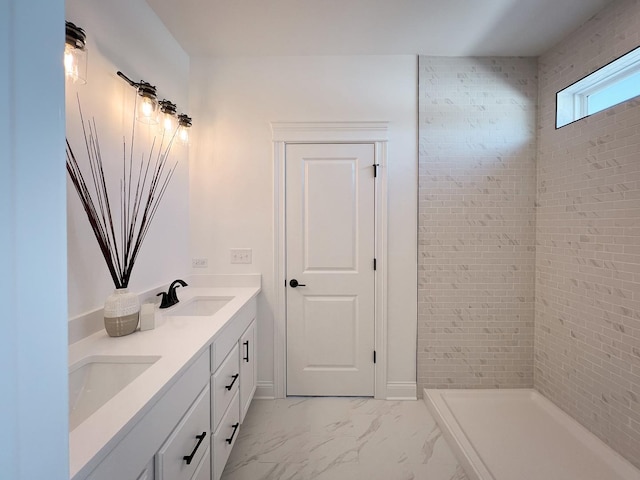 bathroom with vanity and tiled shower