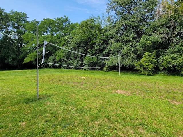 view of community featuring a lawn and volleyball court