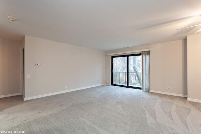 empty room with light colored carpet and baseboards