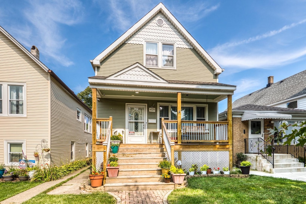 view of front of home with covered porch and a front yard