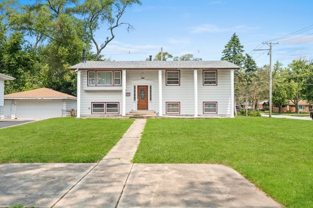 bi-level home with a garage and a front yard