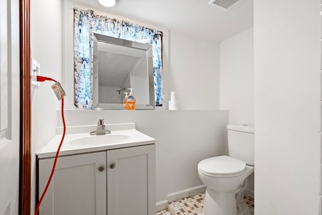 bathroom featuring vanity, toilet, and tile patterned flooring