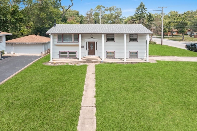 raised ranch with an outbuilding, a garage, and a front yard