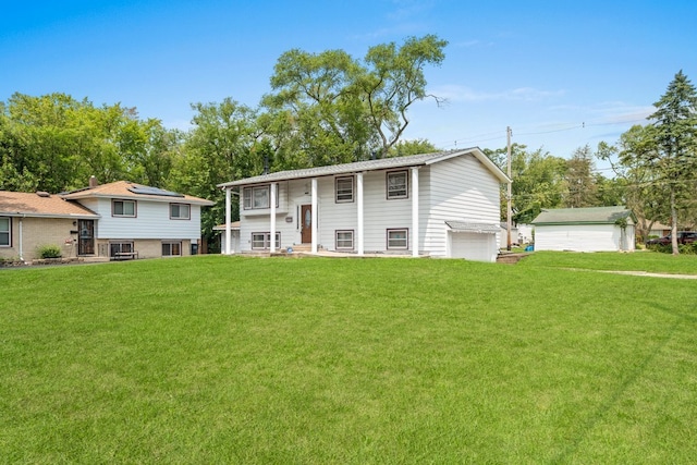 split foyer home with a garage and a front yard