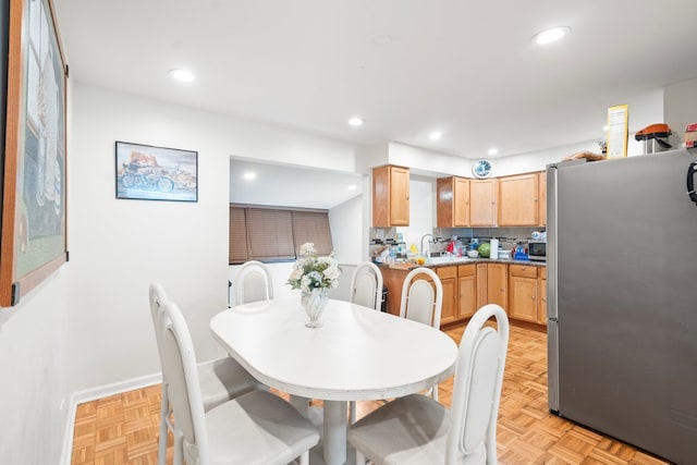 dining room with light parquet flooring and sink