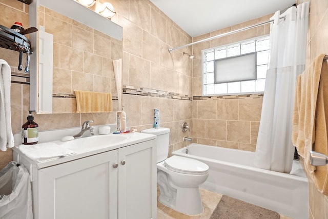 full bathroom with tile patterned flooring, toilet, vanity, tile walls, and shower / bath combo with shower curtain