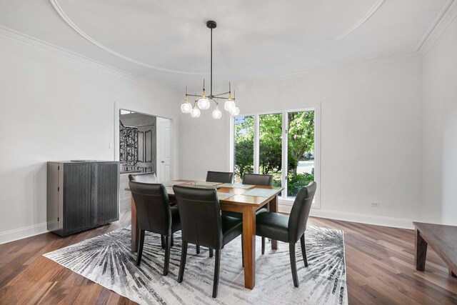 dining space with baseboards, wood finished floors, and ornamental molding