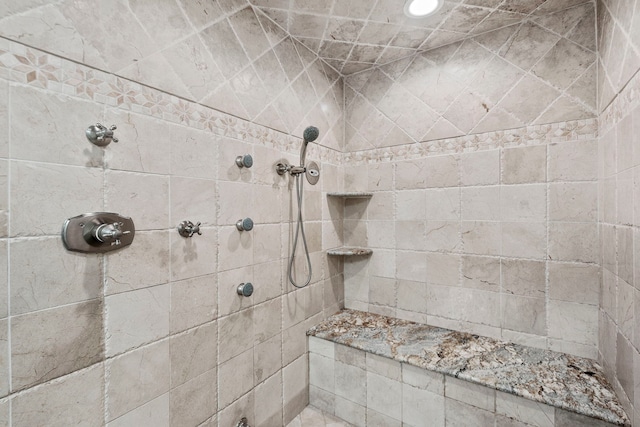 full bath with a tile shower