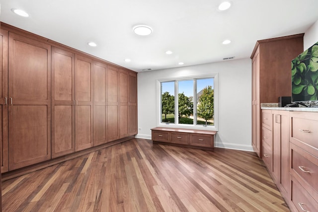 unfurnished bedroom with recessed lighting, visible vents, baseboards, and wood finished floors