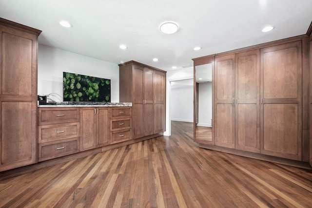 interior space with wood finished floors and recessed lighting