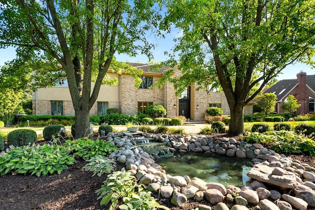 view of front of property with a garden pond