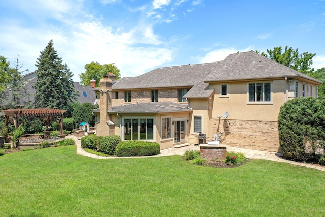 rear view of house featuring brick siding, a lawn, a chimney, a pergola, and stucco siding