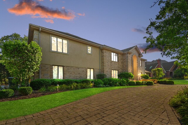 view of front of house with brick siding and stucco siding