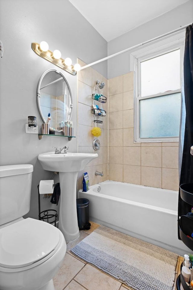 bathroom with toilet, tile patterned floors, and shower / tub combo with curtain