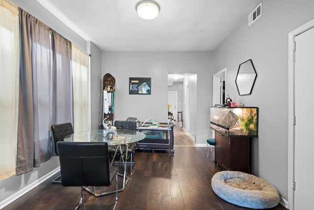 dining space with dark hardwood / wood-style flooring