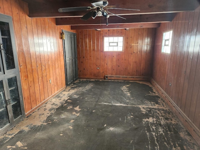 basement with plenty of natural light and wooden walls