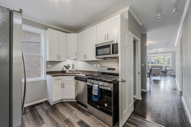 kitchen featuring white cabinets, appliances with stainless steel finishes, and sink