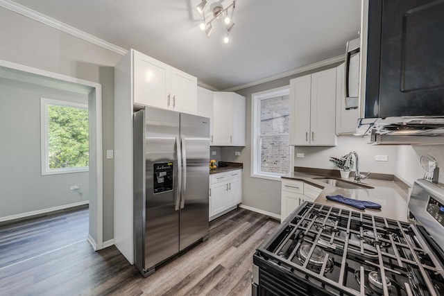 kitchen with white cabinets, appliances with stainless steel finishes, dark hardwood / wood-style flooring, and sink