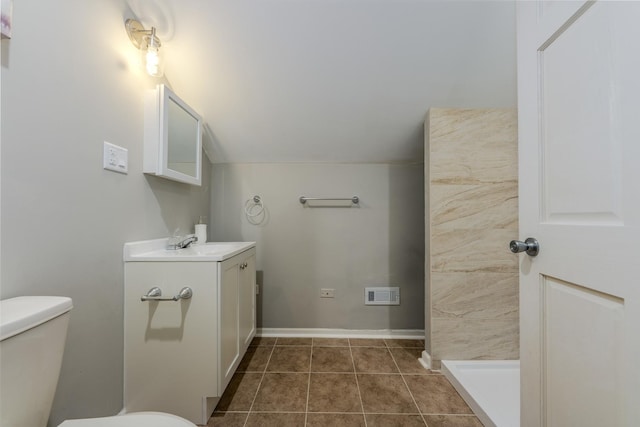 bathroom with toilet, tile patterned flooring, and vanity