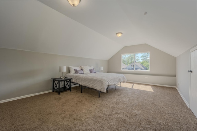 carpeted bedroom with lofted ceiling