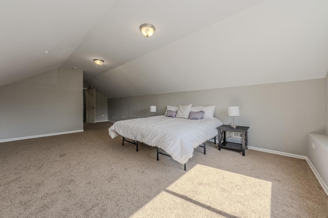 bedroom with vaulted ceiling and carpet