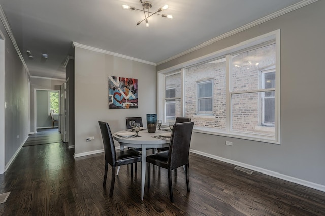 dining area featuring dark hardwood / wood-style flooring, an inviting chandelier, and crown molding