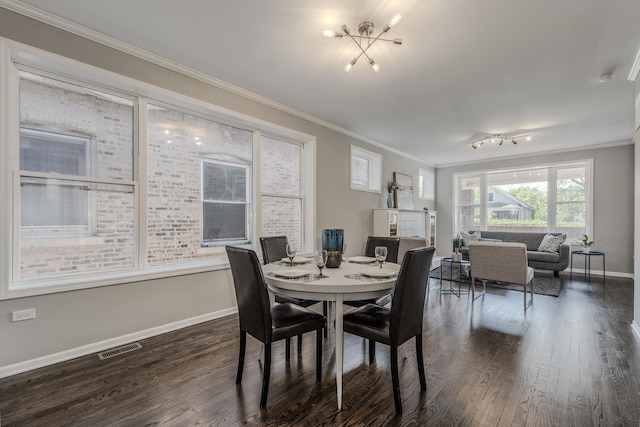 dining area with ornamental molding and dark hardwood / wood-style floors