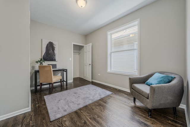 sitting room with dark hardwood / wood-style floors and plenty of natural light