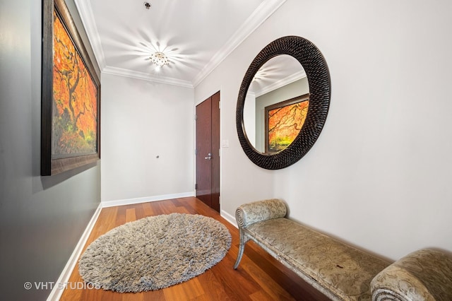 foyer featuring crown molding, baseboards, and wood finished floors