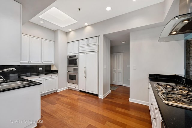 1250 S Michigan Ave Unit 2900, Chicago, IL 60605 - kitchen featuring stainless steel appliances, a skylight, a sink, and light wood finished floors