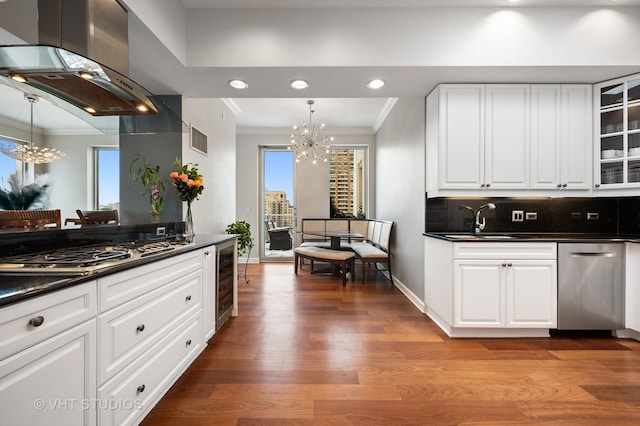 1250 S Michigan Ave Unit 2900, Chicago, IL 60605 - kitchen with dark countertops, an inviting chandelier, island exhaust hood, and stainless steel appliances