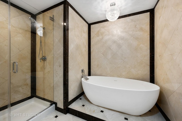 1250 S Michigan Ave Unit 2900, Chicago, IL 60605 - full bath featuring tile patterned flooring, a shower stall, a freestanding bath, and tile walls