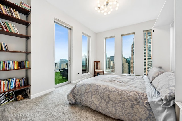 1250 S Michigan Ave Unit 2900, Chicago, IL 60605 - carpeted bedroom with access to exterior, baseboards, and an inviting chandelier