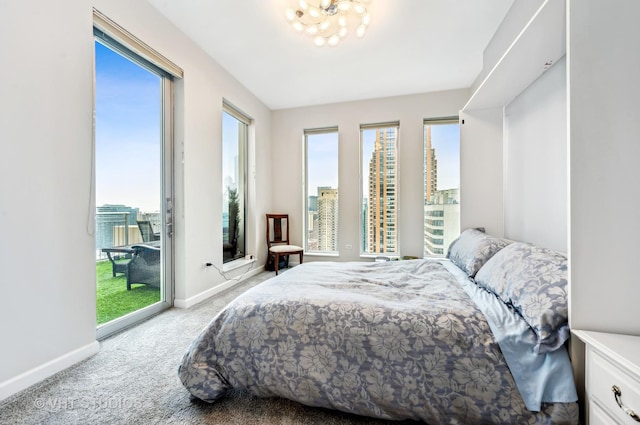 1250 S Michigan Ave Unit 2900, Chicago, IL 60605 - bedroom featuring carpet floors, access to outside, baseboards, and an inviting chandelier