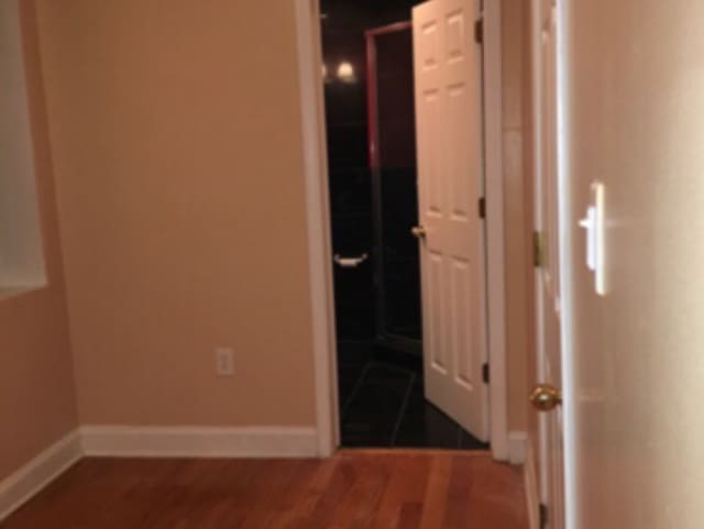 hall with dark hardwood / wood-style floors