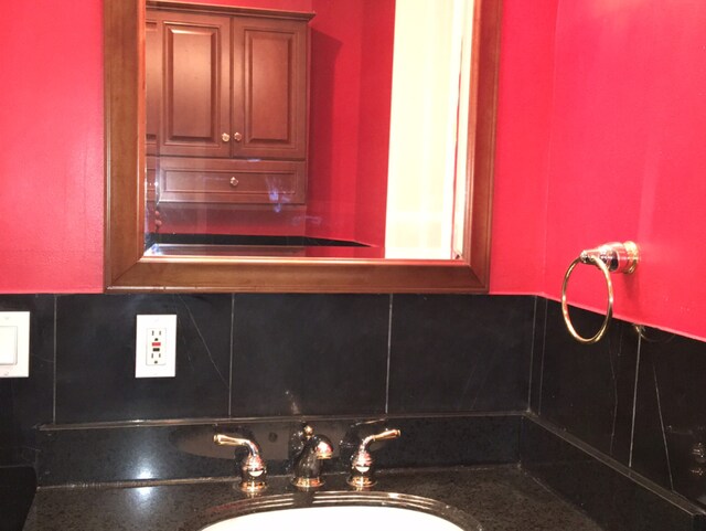 interior details featuring sink and tasteful backsplash